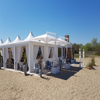 White side arm parasols shading an outdoor patio on the beach 