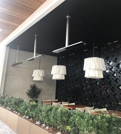 electric heaters installed overtop of a restaurant patio installed on the ceiling