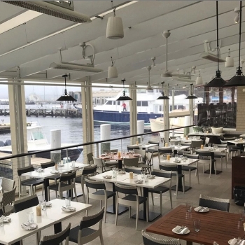 a series of white heaters along the ceiling of a restaurant patio