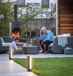 led lighting features along the walk way of a home with people sitting nearby