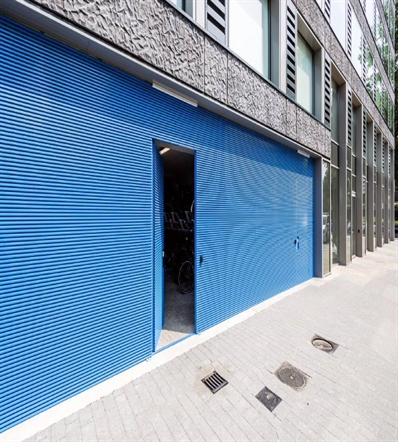 blue aluminum cladding that's horizontal on a building with an integrated door