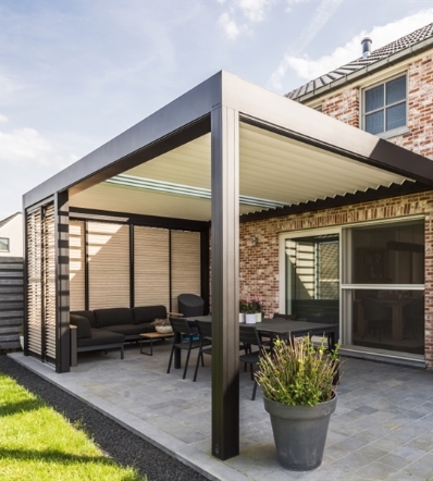Patio retractable louvered pergola with translucent glass blades incorporated into the louvers