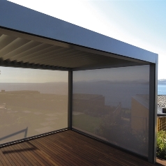 Retraceable pergola with screens on sides to enclose