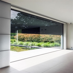 motorized screens that are black installed on the outside of a window shown from inside out