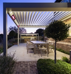 Integrated roof beam heaters lite under a retractable pergola patio