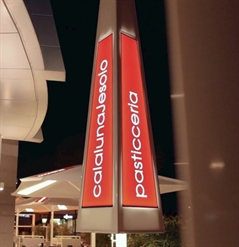 a large white umbrella with red led lighting panels that have the restaurant name integrated 