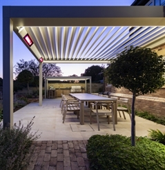 aluminum louvred bioclimatic awning with integrated heaters attached to home during the night time