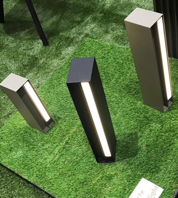 small black led lighting sitting on fake grass displayed at a tradeshow