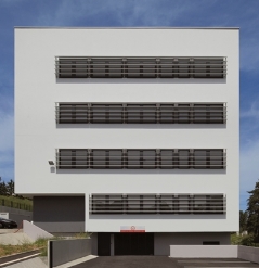 Long horizontal windows of a building sun protected with aluminum louvres