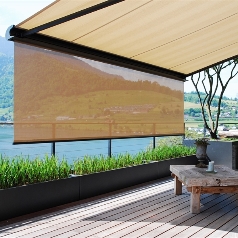 cream colour fabric awning with a drop down roller screen installed over a residential patio