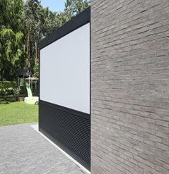 Black aluminum cladding forms a half wall of an outdoor patio area with screen above
