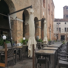 Closed Pensile parasol shown on outdoor dining restaurant