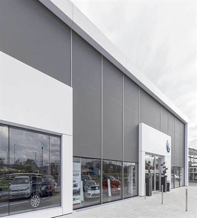grey external screens on the large windows of a car dealership