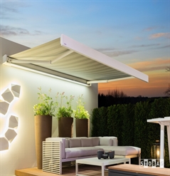 white striped awning attached to a simple white home with led lighting during the night time