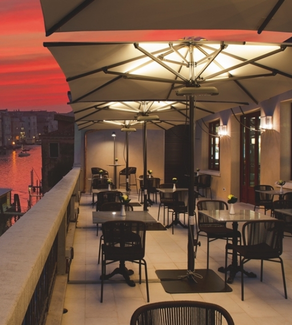 Parasols with back lighting in evening opened over a patio restaurant