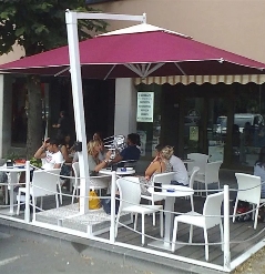Burgundy Pensile parasol over outdoor seating area for café