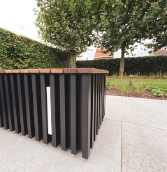 close up of the corner of an aluminum seating block with integrated led lighting and a wooden top