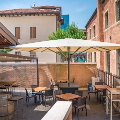 Cream parasol opened to shade a restaurant patio
