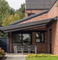 a red brick home with a pvc pergola attached to its wall that's fully extended