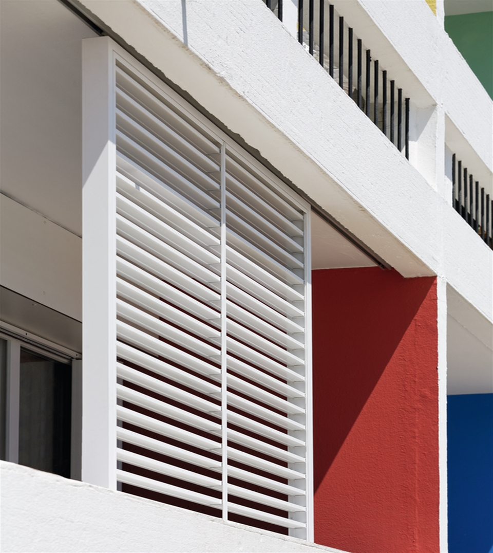 Renson sliding shutter panels on an apartment building