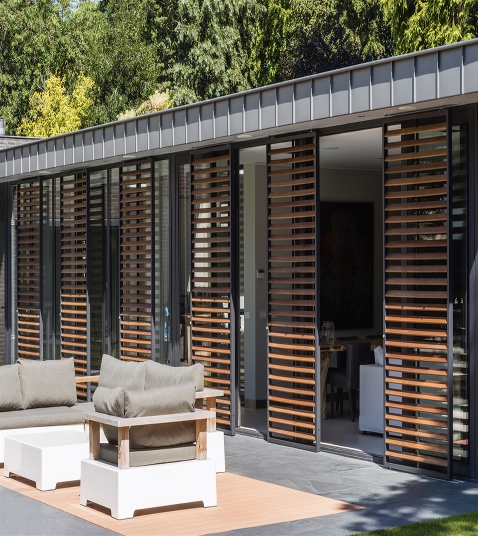 Loggia sliding shutter panels with wooden louvres installed at a private residence