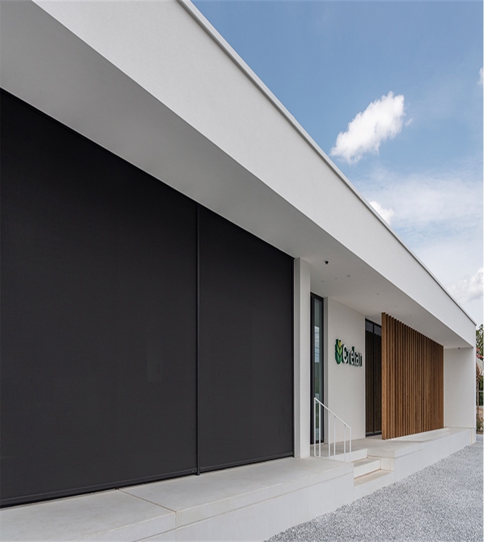 black screen integrated into the facade of a building for sun protection
