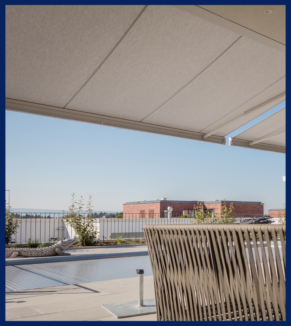 a white fabric awning extended for sun protection attached to the side of a home a white fabric awning extended for sun protection attached to the side of a home