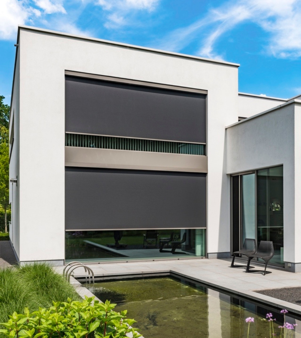 black external motorized blinds surface mounted on the exterior of a home