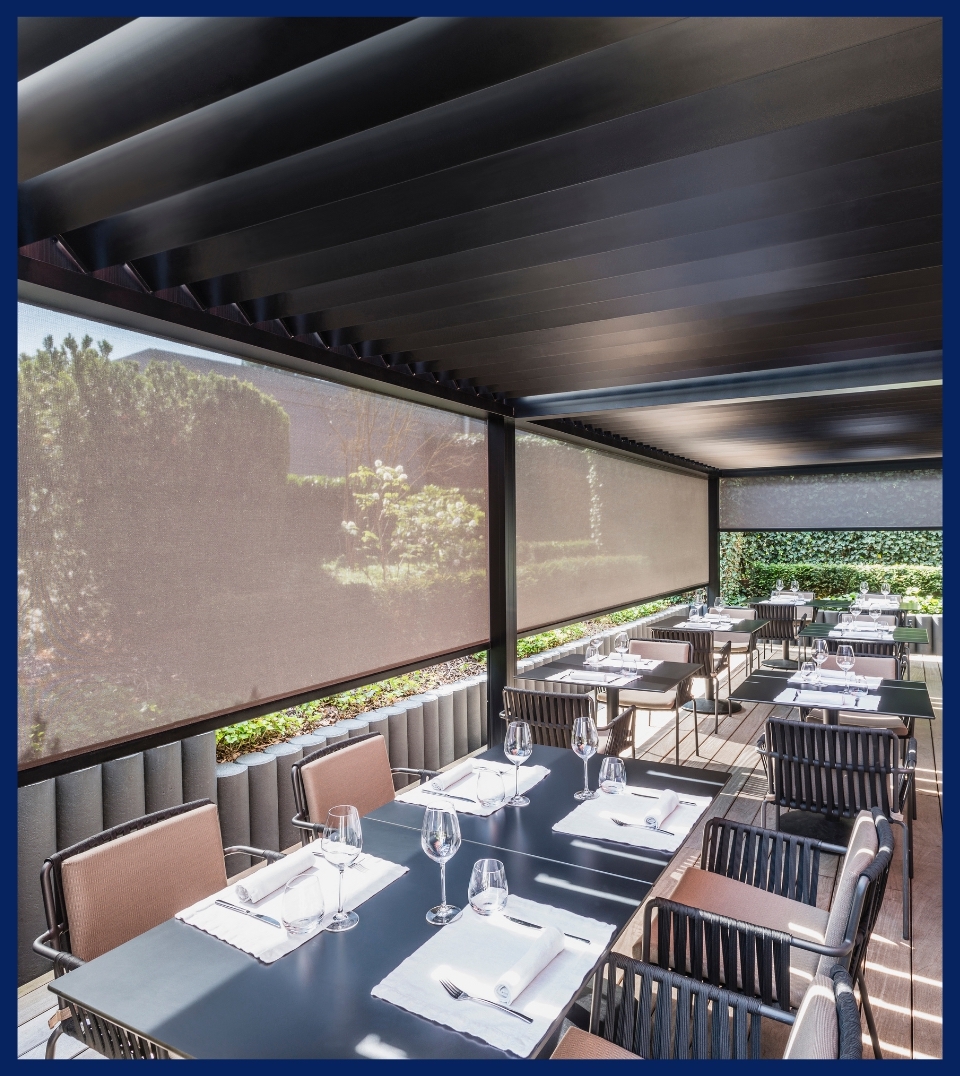 black fabric screens that are see-through enclosing a restaurant patio
