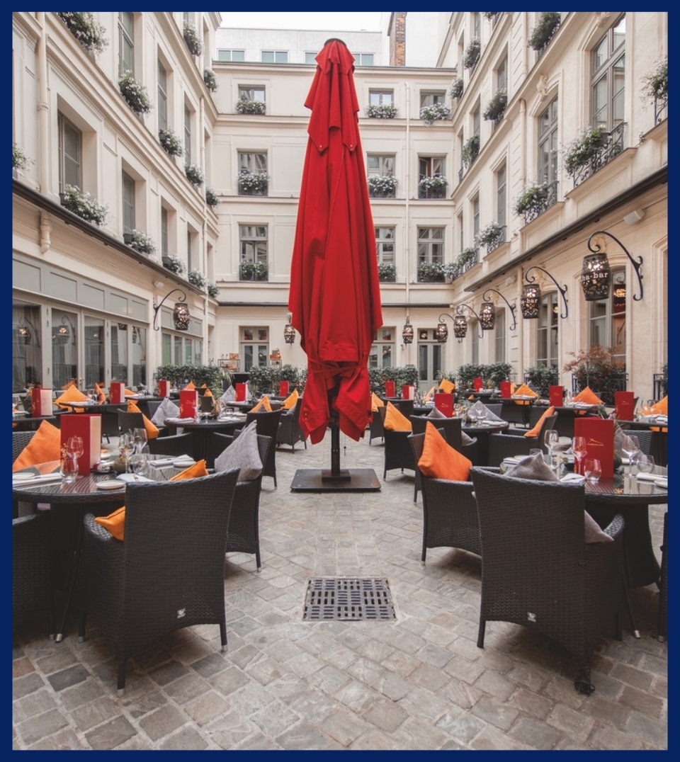 red umbrella closed together in the middle of a public city patio