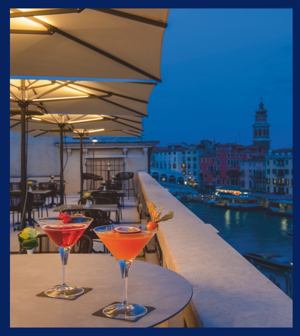 yellow patio umbrellas with LED lighting strips in the ribs covering the patio of a rooftop area