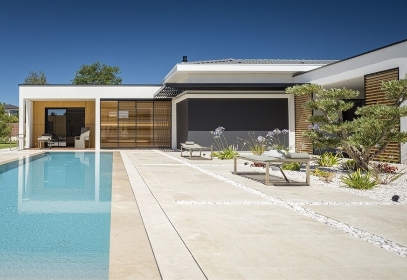 Modern home design with external motorized blinds and sliding louvered shutter panels Modern home design with external motorized blinds and sliding louvered shutter panels