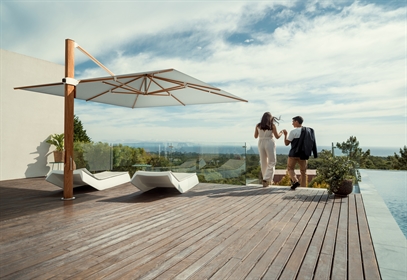 A side post umbrella with white fabric and wood style fixings