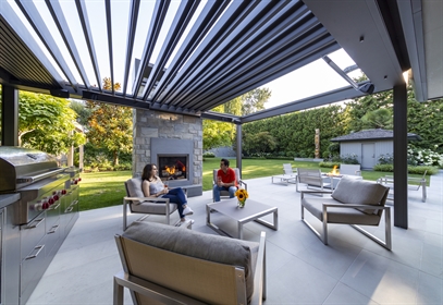 grey louvered retractable canopy in summer on porch with screens and heater