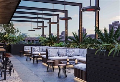 Modern rooftop lounge with round pendant heaters and cushioned seating