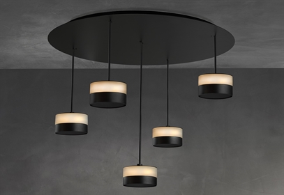 Cluster of five black and white pendant lights on a dark ceiling mount.