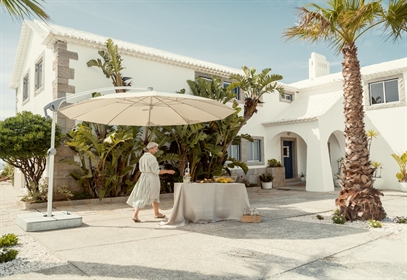 Light coloured umbrella in the backyard of a traditional style home