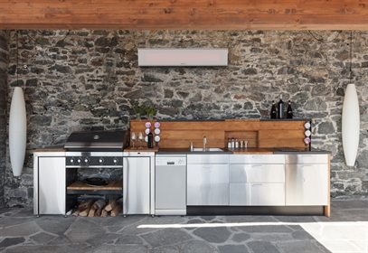 Modern outdoor kitchen with appliances and wall-mounted heater