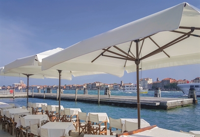 Heavy-duty Gaggio commercial parasol with a nautical pulley system at a res