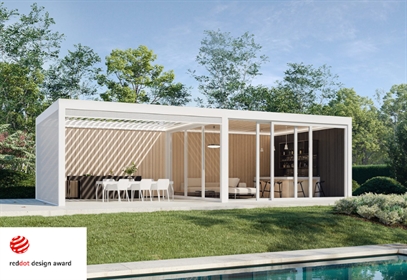 Modern poolside poolhouse with dining and lounge areas lit for evening use