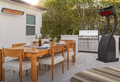 Patio with grill, dining set, and two outdoor heaters.