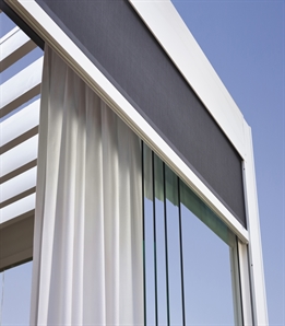 grey curtains integrated inside the frame of a louvred roof system for privacy and design