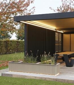 black strip privacy facade wall integrated into a pergola with louvres