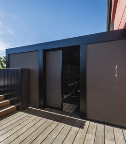 brown canvas sliding door integrated on the side of a pergola system