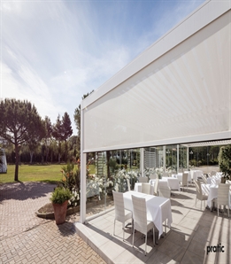 White Motorized Screens Integrated in a White Louvered Pergola