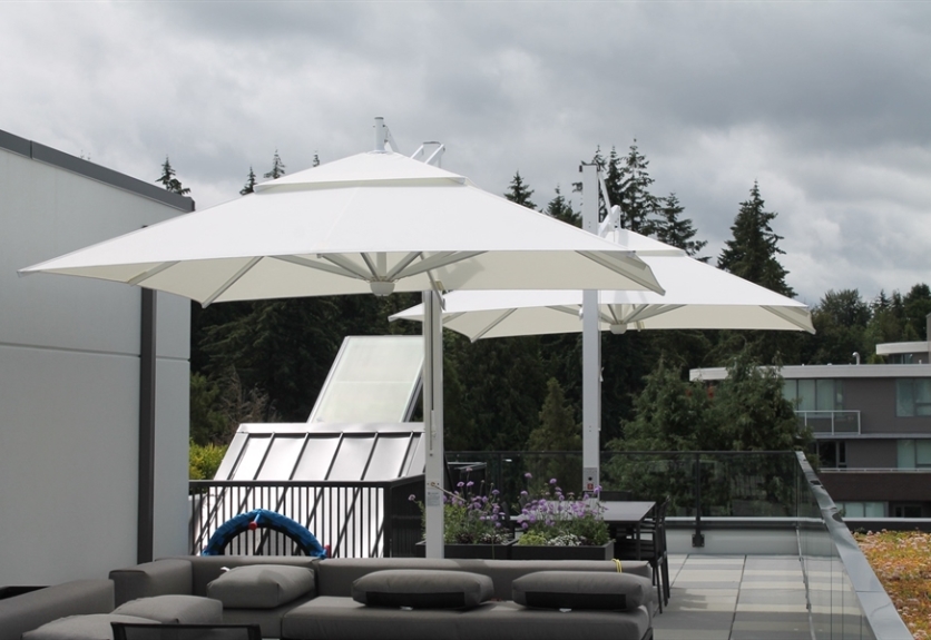 Two white umbrellas cover a rooftop deck