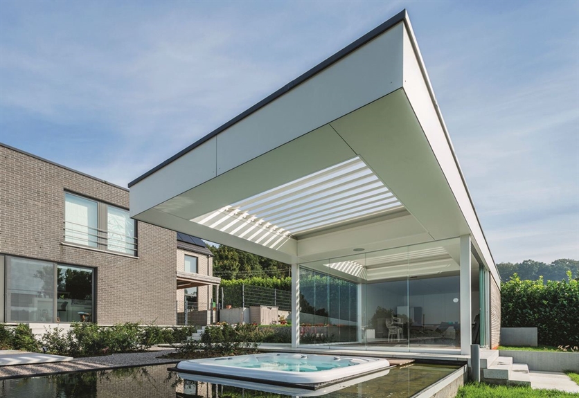 A white pergola sits on top of a pool on a sunny day