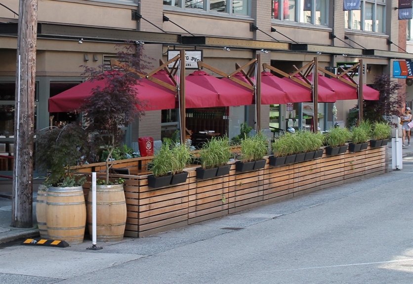 a restaurant with red umbrellas on the patio