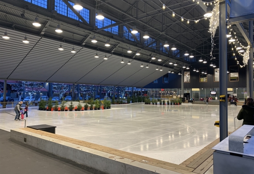 Lights illuminate a skating rink under the Byart Pergoline structure