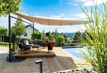 Luxury vaulted sun sail by Bahama over a designer pool deck.